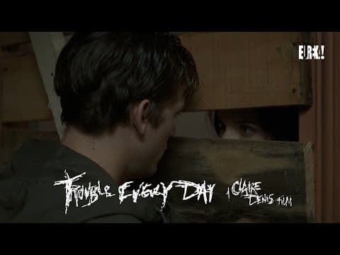 Coré encounters a man in a drab apartment